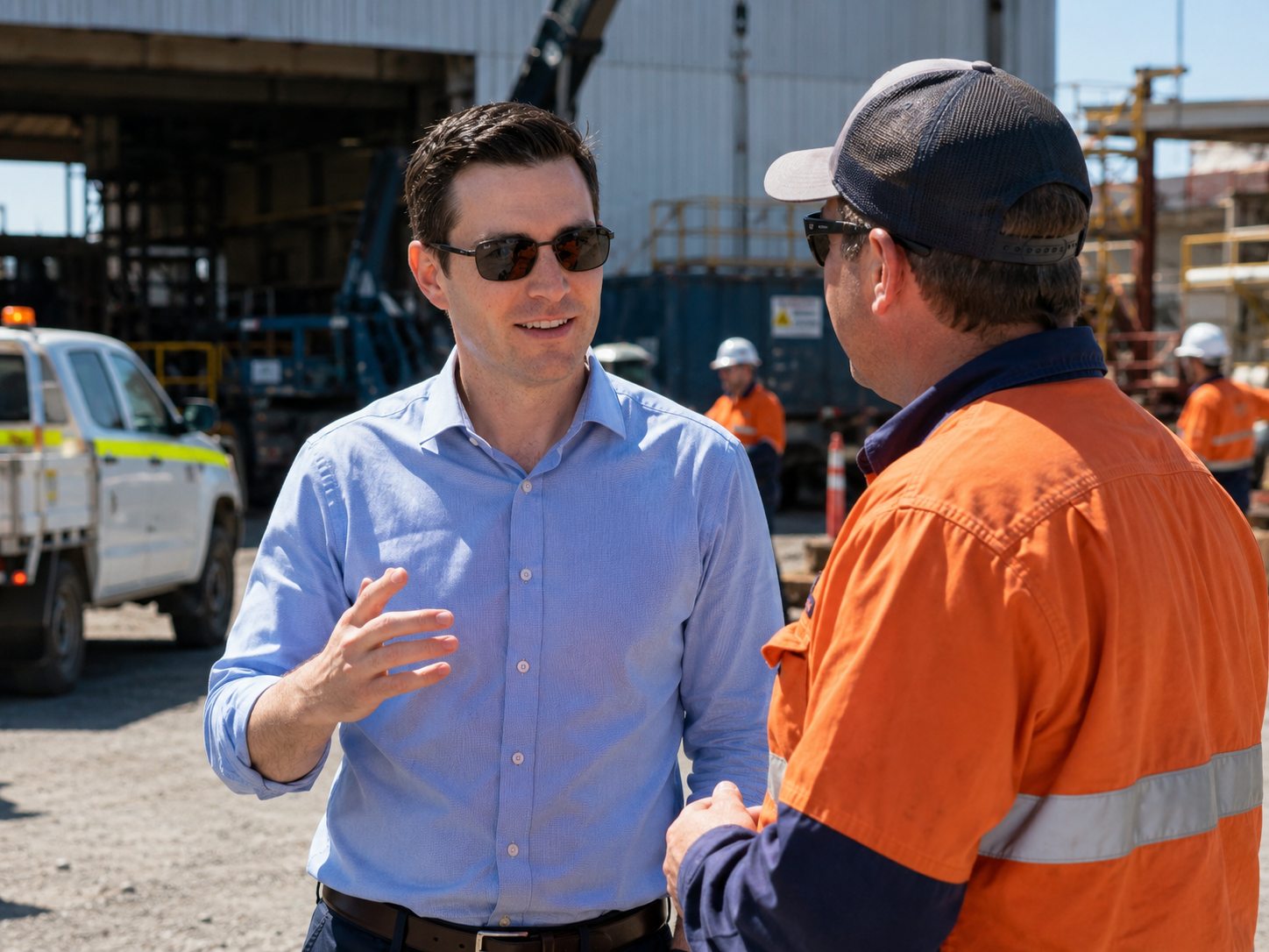 Adrian Simons speaking with a worker on an operational site